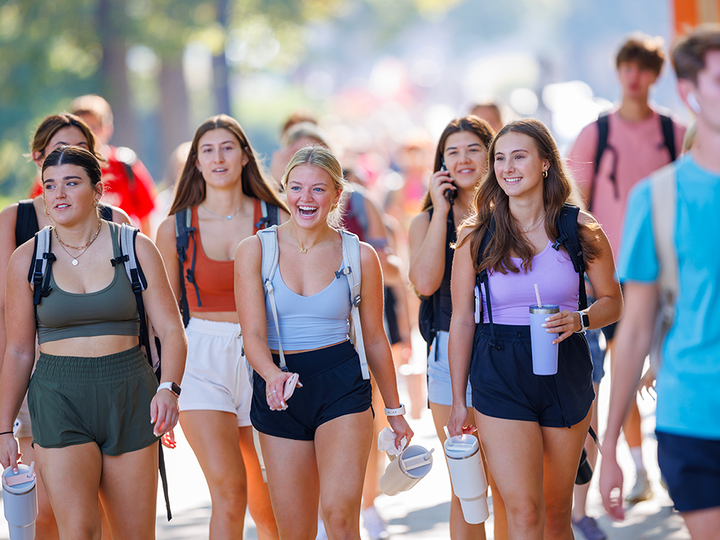 Students walk across UNL city campus on a wonderful sunny day