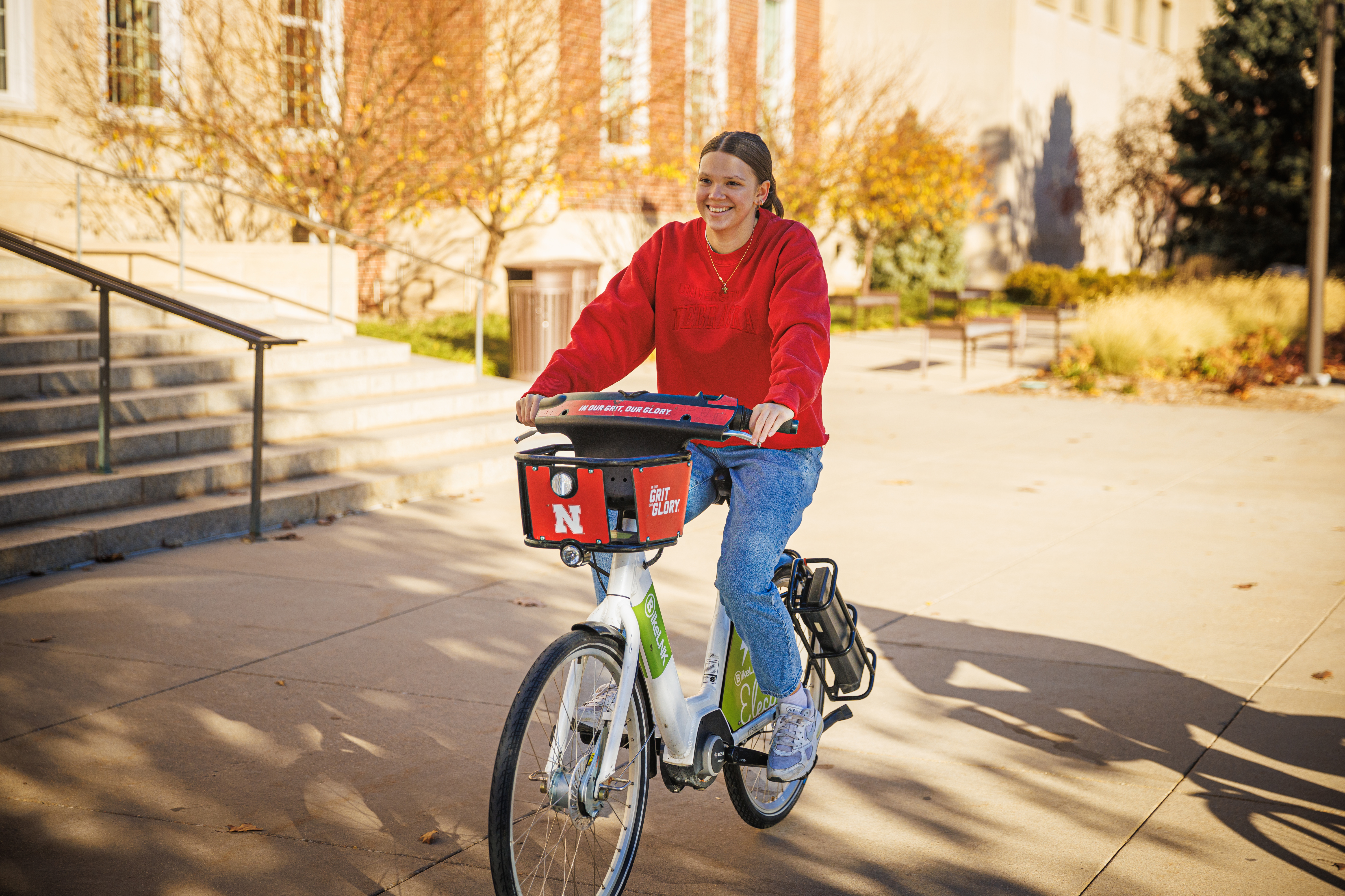 A student rides a BikeLNK electric bike